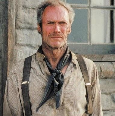Clint Eastwood w starszym wieku, stojący na planie filmowym lub w subtelnym krajobrazie westernowym, symbolizujący jego długą i wpływową karierę w Hollywood.
